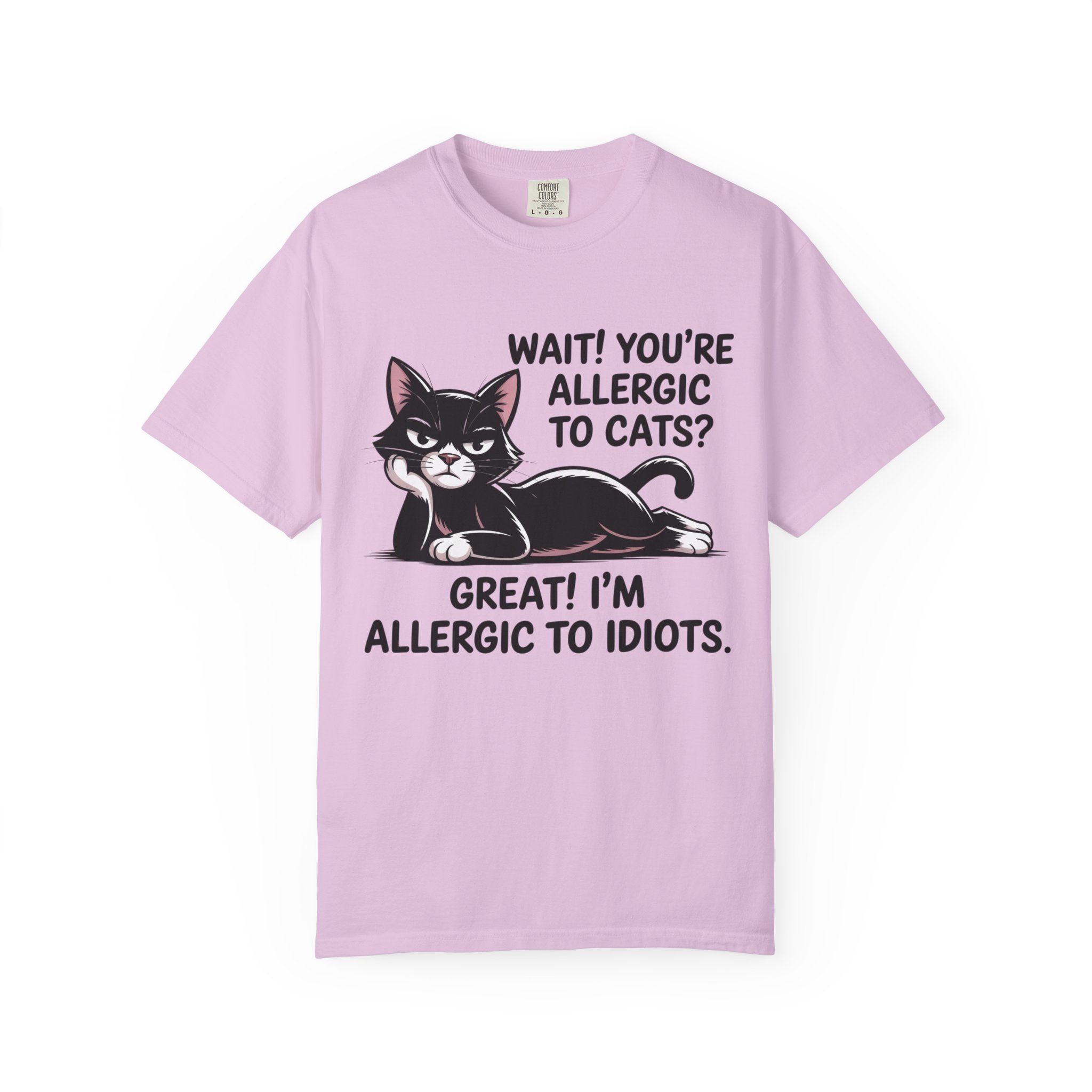 A light purple short-sleeve t-shirt with a graphic of a black and white cat and the text 'WAIT! YOU'RE ALLERGIC TO CATS? GREAT! I'M ALLERGIC TO IDIOTS.' on a white background.