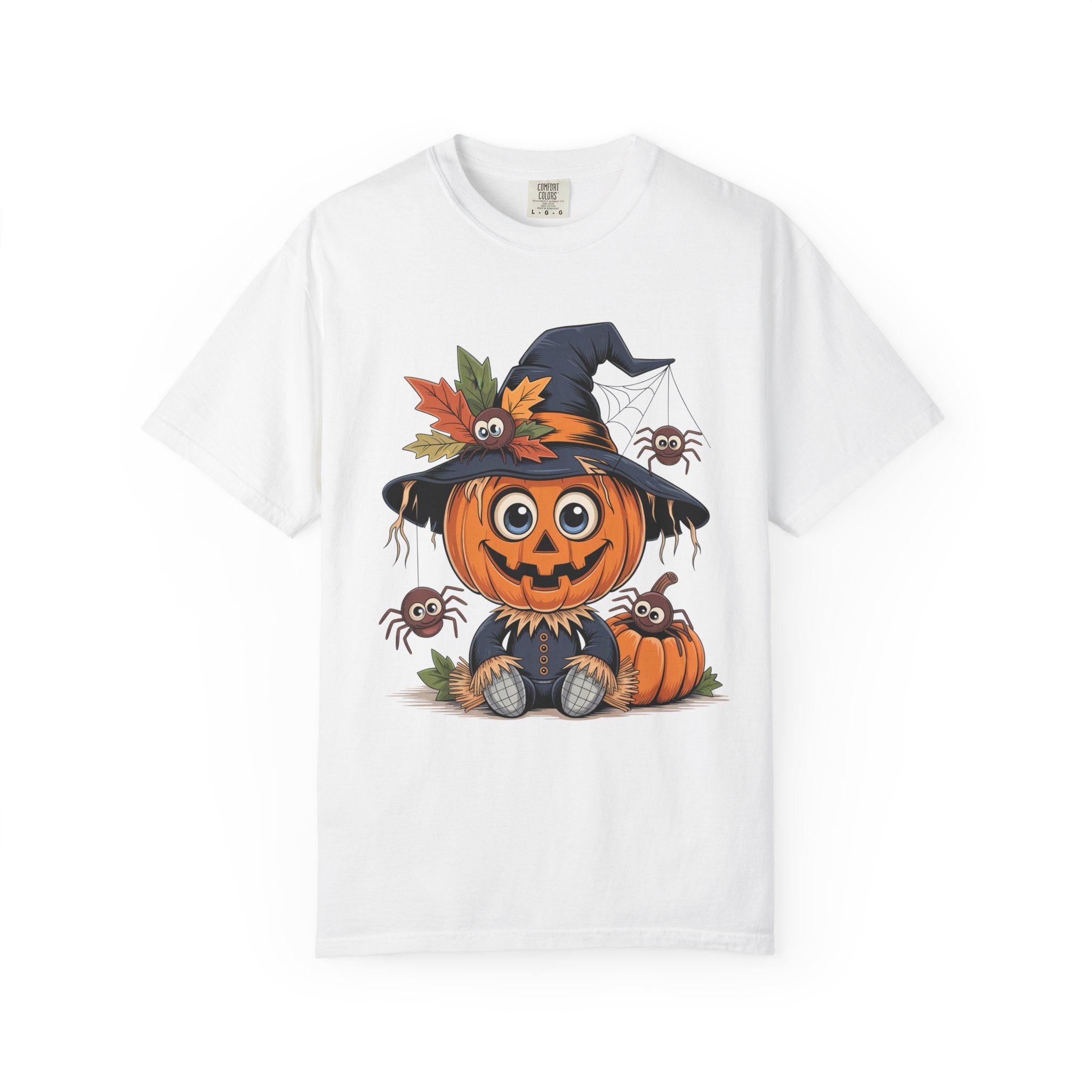 A white short-sleeve crewneck t-shirt featuring a colorful cartoon graphic of a smiling jack-o'-lantern wearing a witch's hat with autumn leaves, surrounded by small spiders.