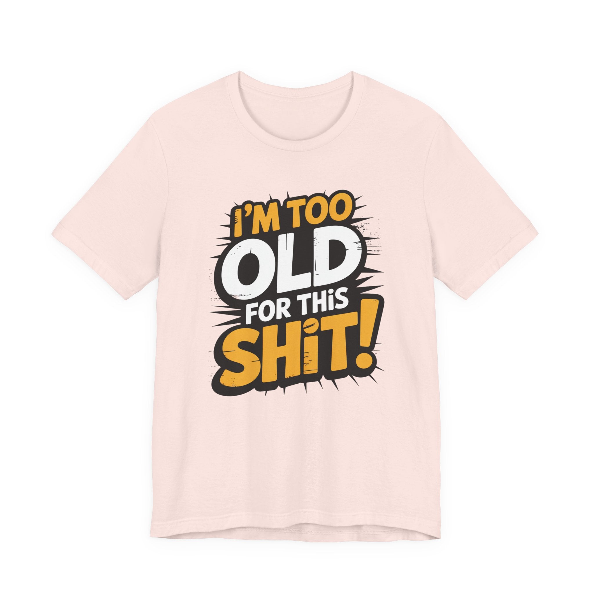 A light pink short-sleeve t-shirt with a bold graphic on the front that reads 'I'M TOO OLD FOR THIS SHi!' in yellow, white, and black comic-style lettering, displayed on a clean white background.