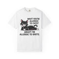 A white short-sleeve crewneck t-shirt featuring a graphic of a black and white cat with the text 'WAIT! YOU'RE ALLERGIC TO CATS? GREAT! I'M ALLERGIC TO IDIOTS.' printed on the front.