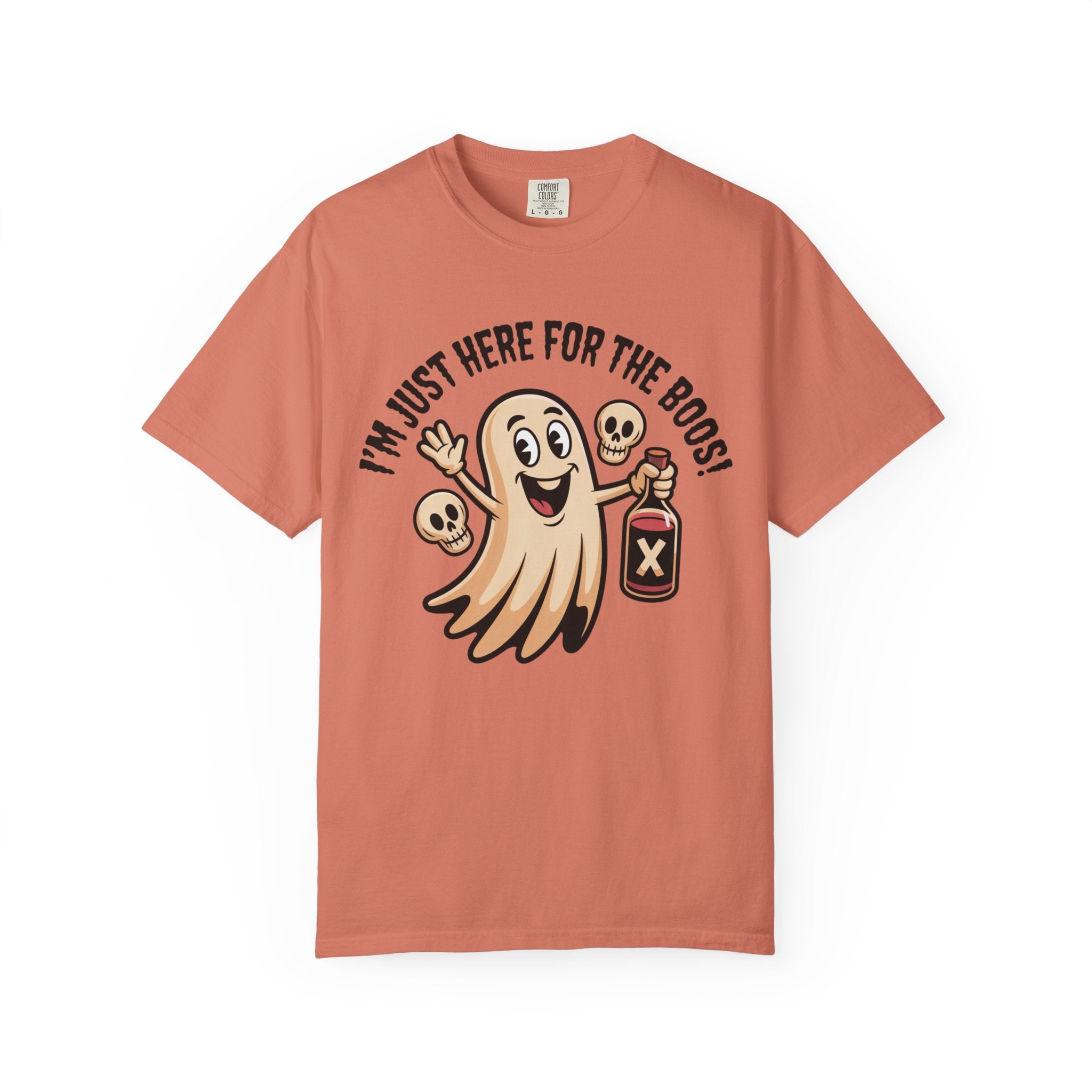 A peach-colored short-sleeve t-shirt with a cartoon graphic of a smiling ghost holding a bottle labeled 'X' and surrounded by skulls, with the text 'I'M JUST HERE FOR THE BOOS!' arched above it, displayed on a clean white background.