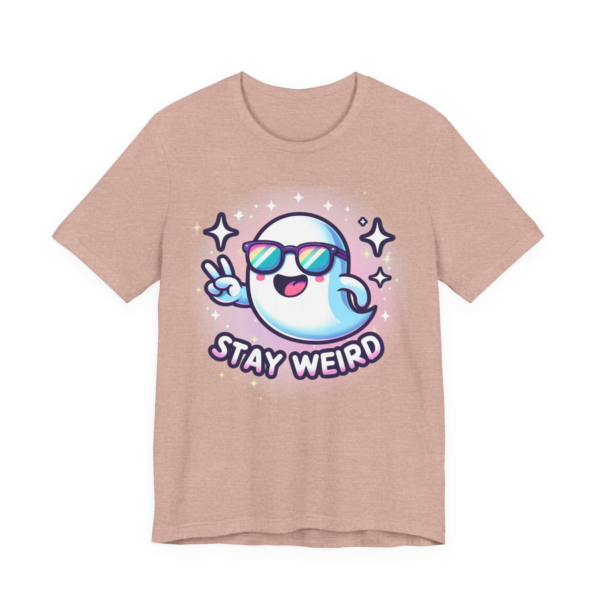 A heathered dusty pink short-sleeve t-shirt featuring a cartoon graphic of a blue and white ghost wearing sunglasses and making a peace sign, with the text 'STAY WEIRD' underneath.