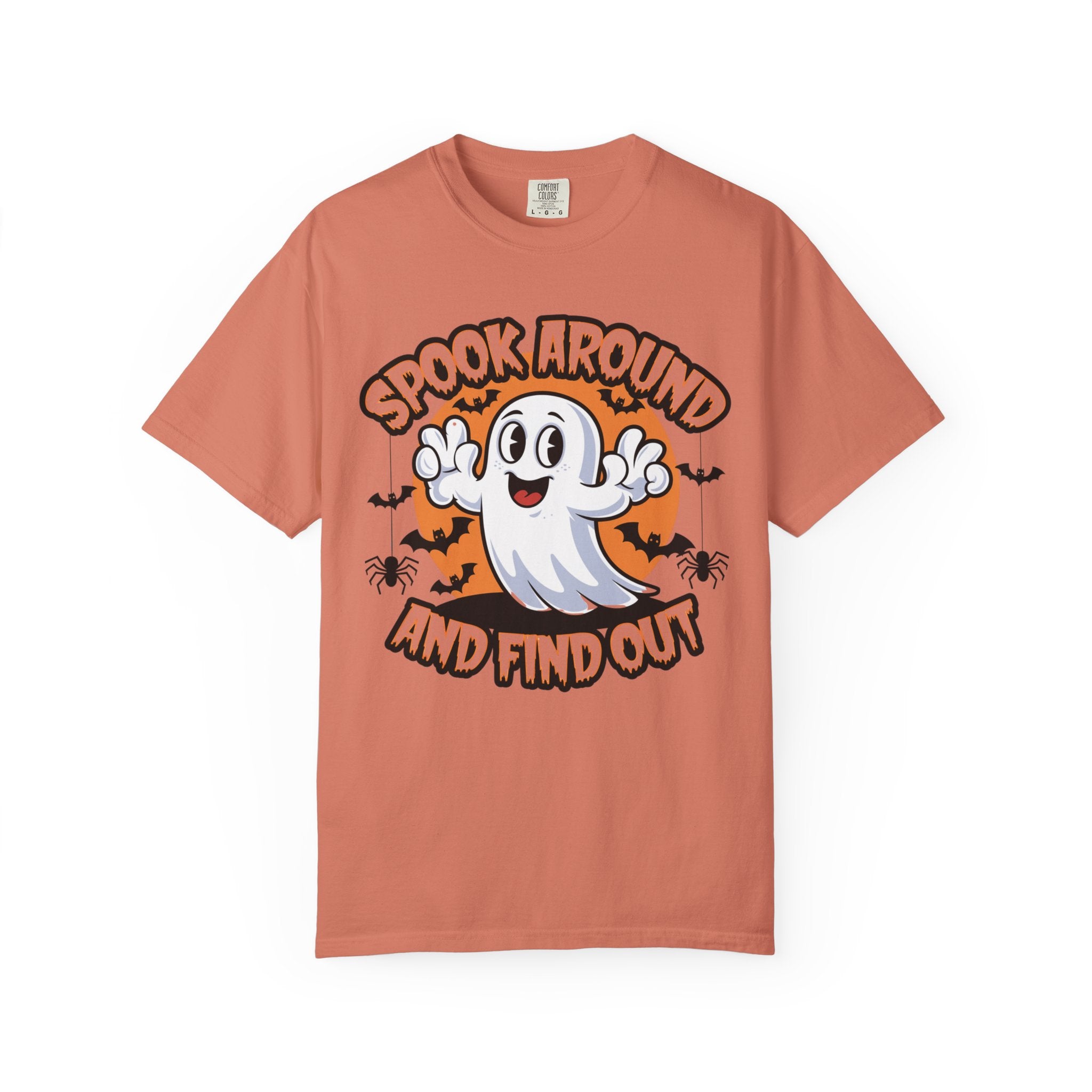 A peach-colored short-sleeve t-shirt with a Halloween graphic featuring a cartoon ghost, bats, spiders, and the text 'SPOOK AROUND AND FIND OUT' on a white background.