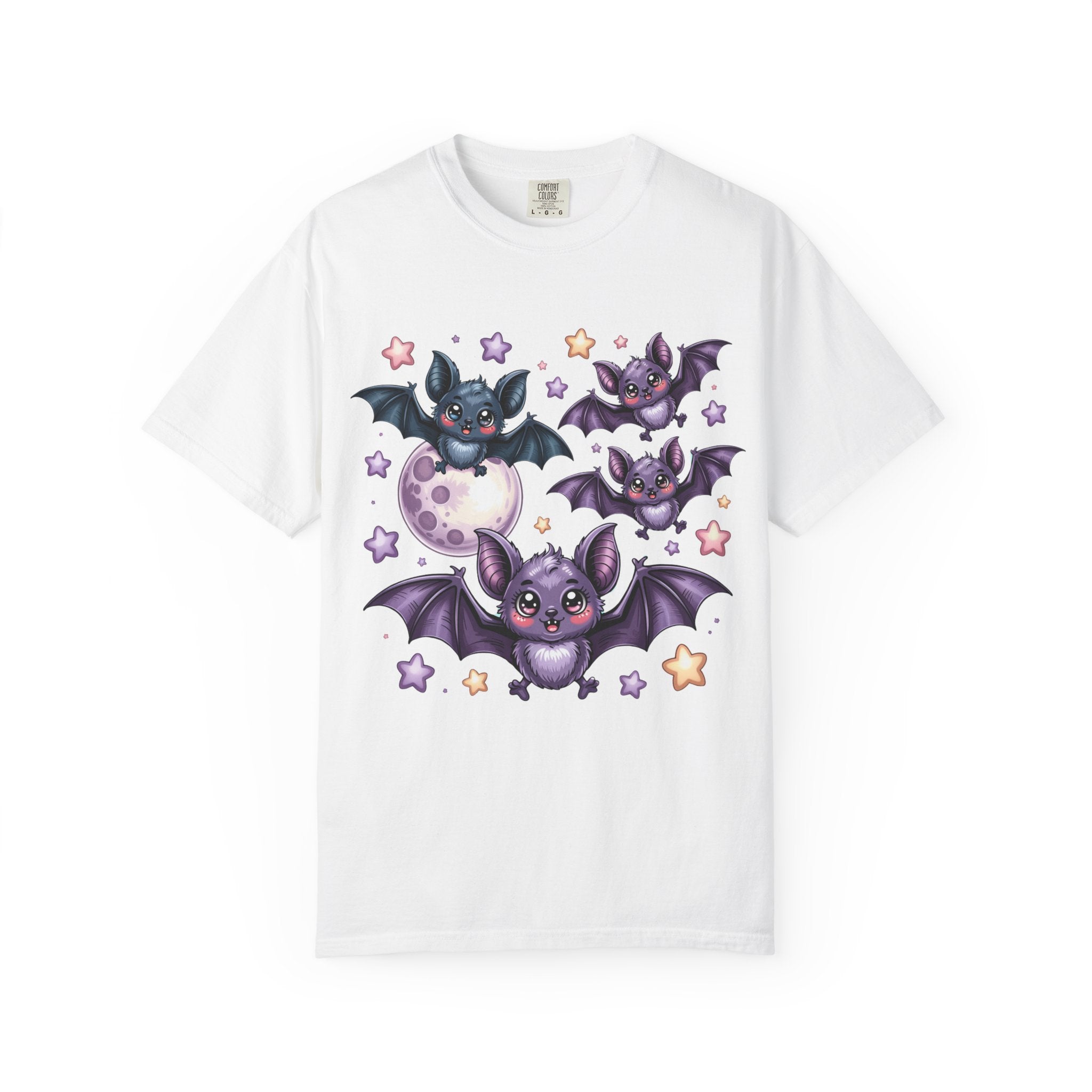 A white short-sleeve crewneck t-shirt featuring a colorful graphic print of three cute purple and black cartoon bats flying around a crescent moon and stars.