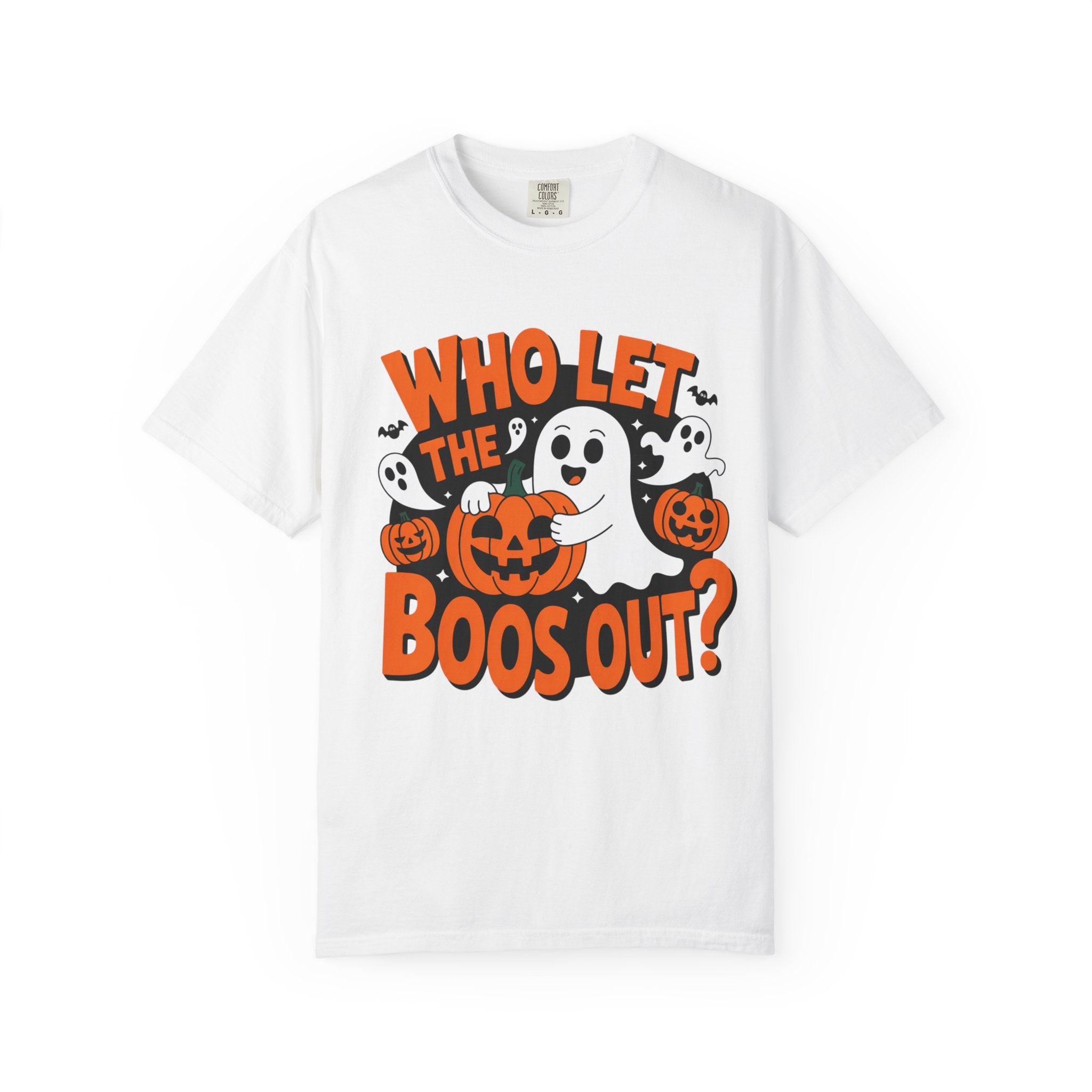 A white short-sleeve crewneck t-shirt featuring a Halloween graphic print with the text 'WHO LET THE BOOS OUT?' in orange, cartoon ghosts, jack-o'-lanterns, and a smiling ghost holding a pumpkin.
