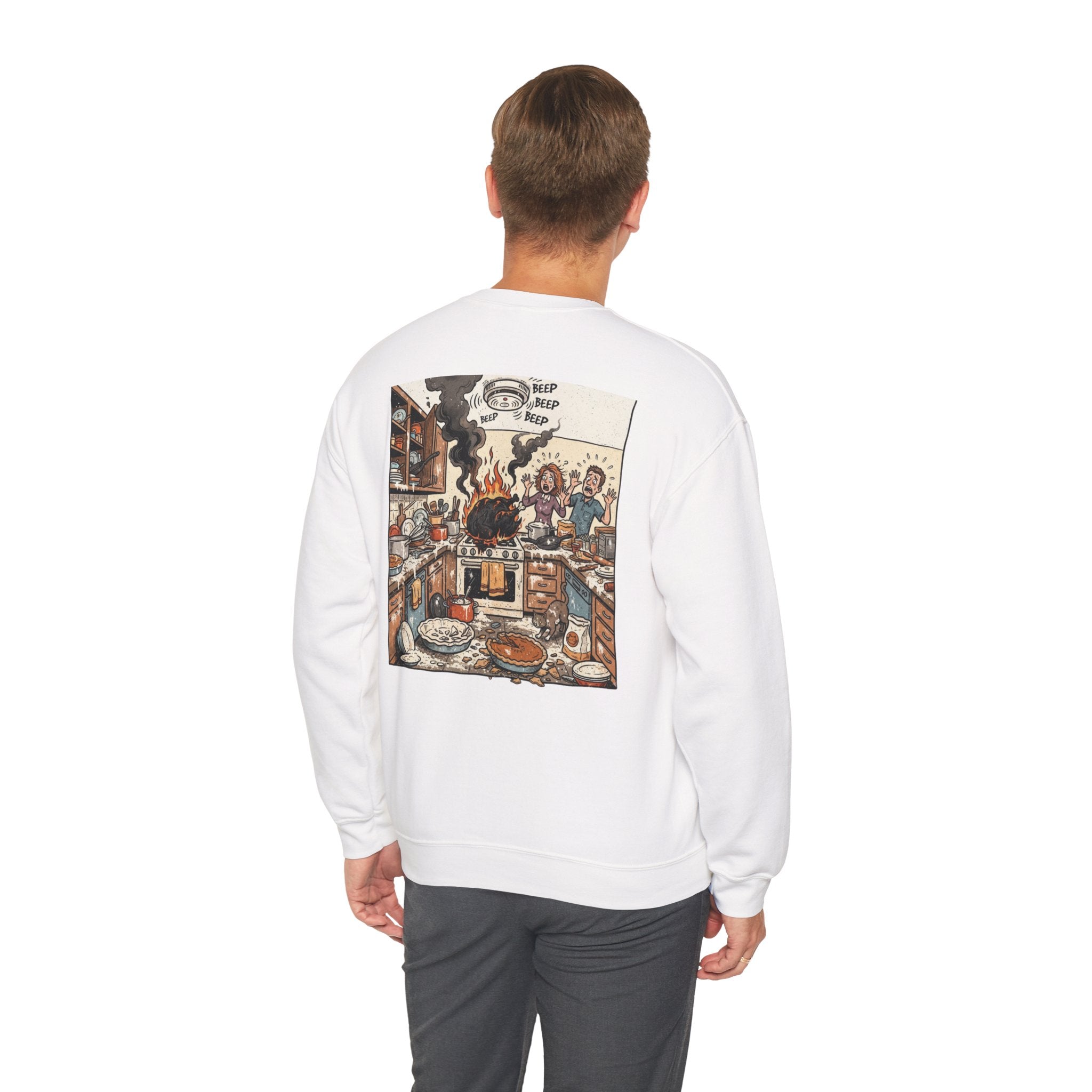 A man viewed from behind wearing a white crewneck sweatshirt with a large, detailed vintage-style illustration printed on the back, paired with dark gray pants, against a plain white background.