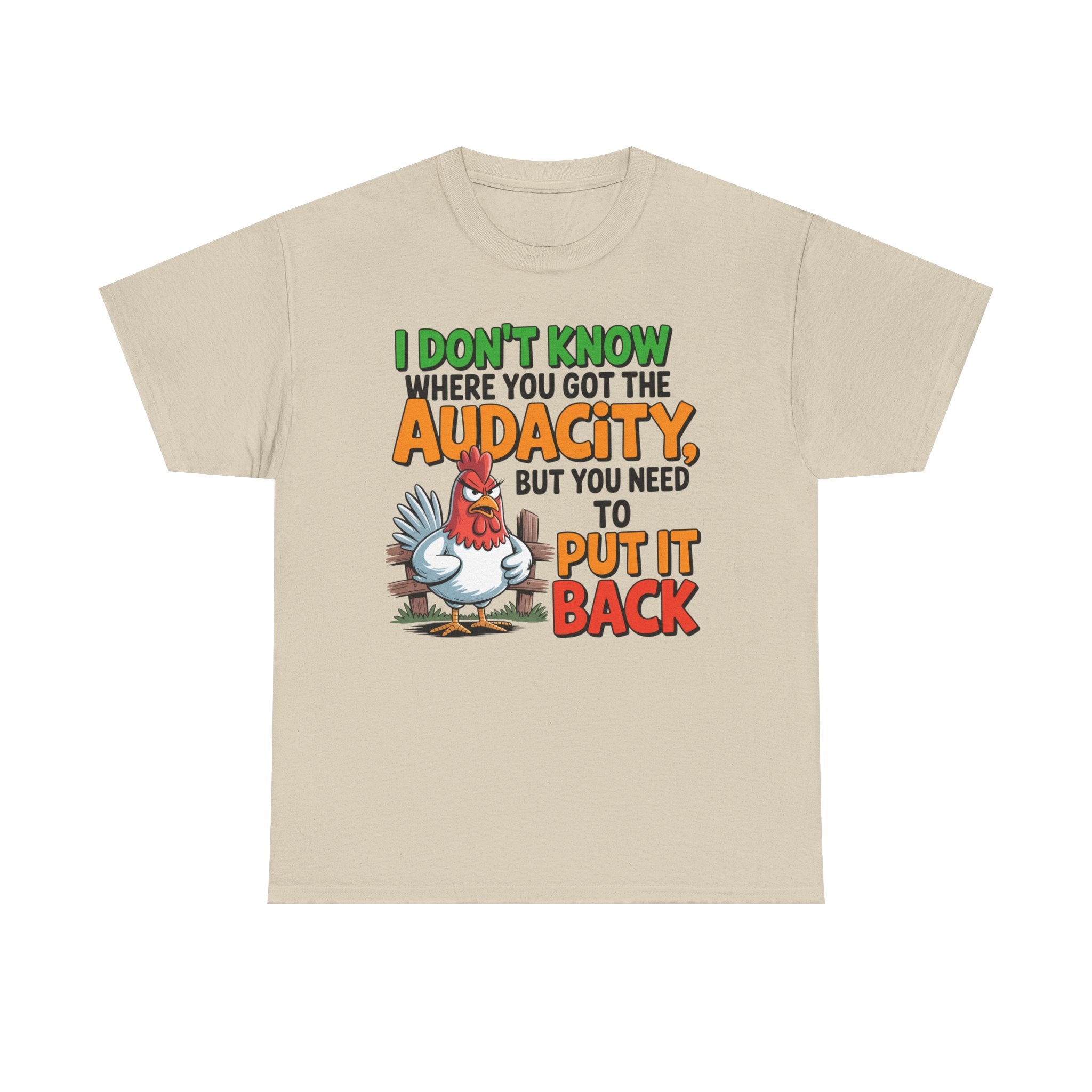 A light beige crewneck t-shirt with a colorful graphic on the front featuring a cartoon rooster and the text 'I DON'T KNOW WHERE YOU GOT THE AUDACITY, BUT YOU NEED TO PUT IT BACK'.