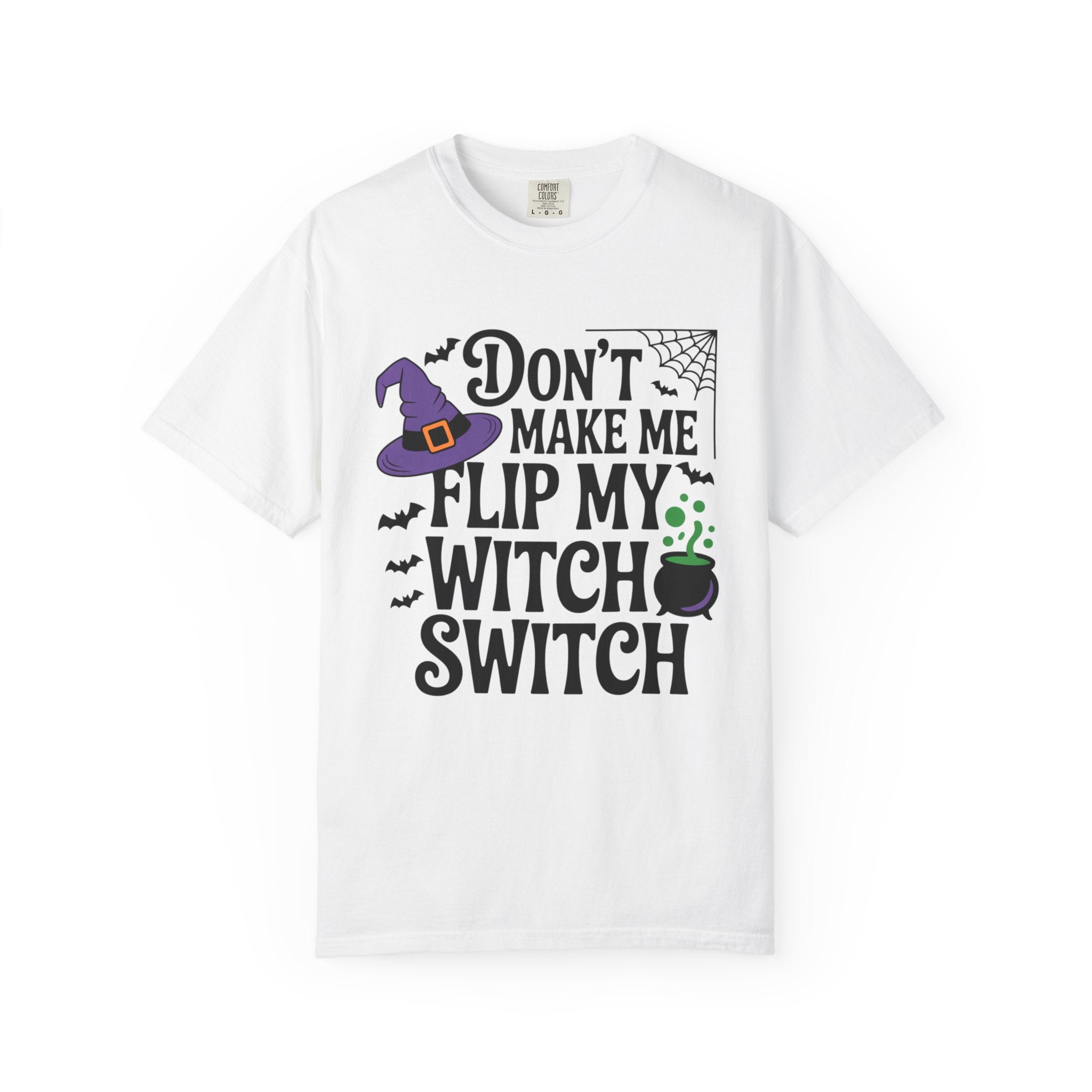 A white short-sleeve crewneck t-shirt with a Halloween-themed graphic print that reads 'DON'T MAKE ME FLIP MY WITCH SWITCH' in black text, accompanied by a purple witch hat, spiderweb, bats, and a cauldron.