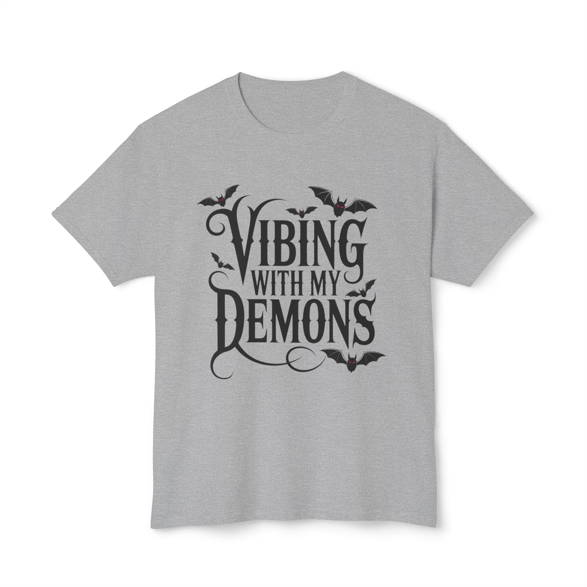 A light gray heather crewneck t-shirt featuring a black graphic print on the front that reads 'Vibing with my demons' in stylized gothic lettering, decorated with small bat silhouettes.