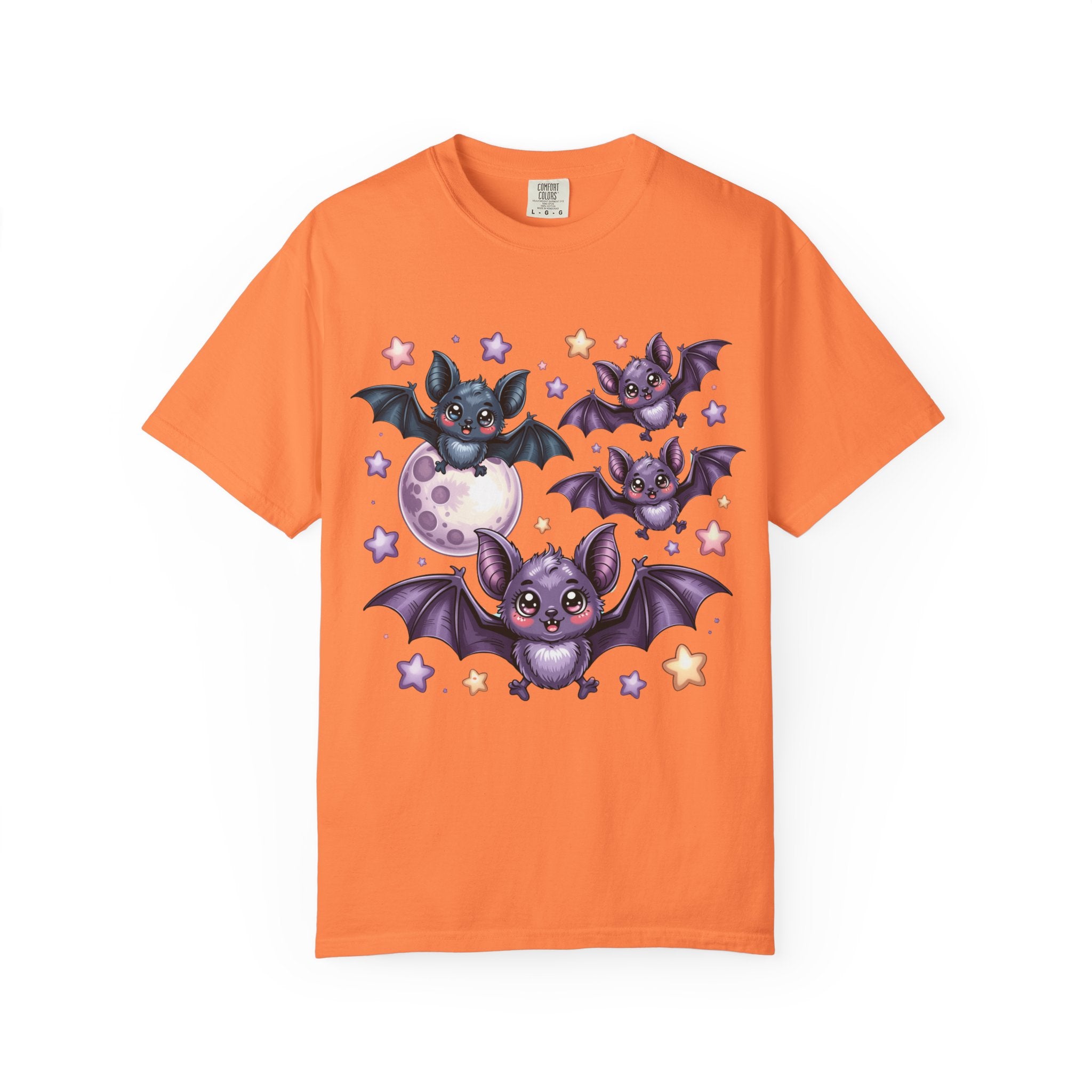 An orange short-sleeve crewneck t-shirt featuring a cute cartoon graphic of four purple bats flying around a moon and stars on the front, displayed against a solid white background.