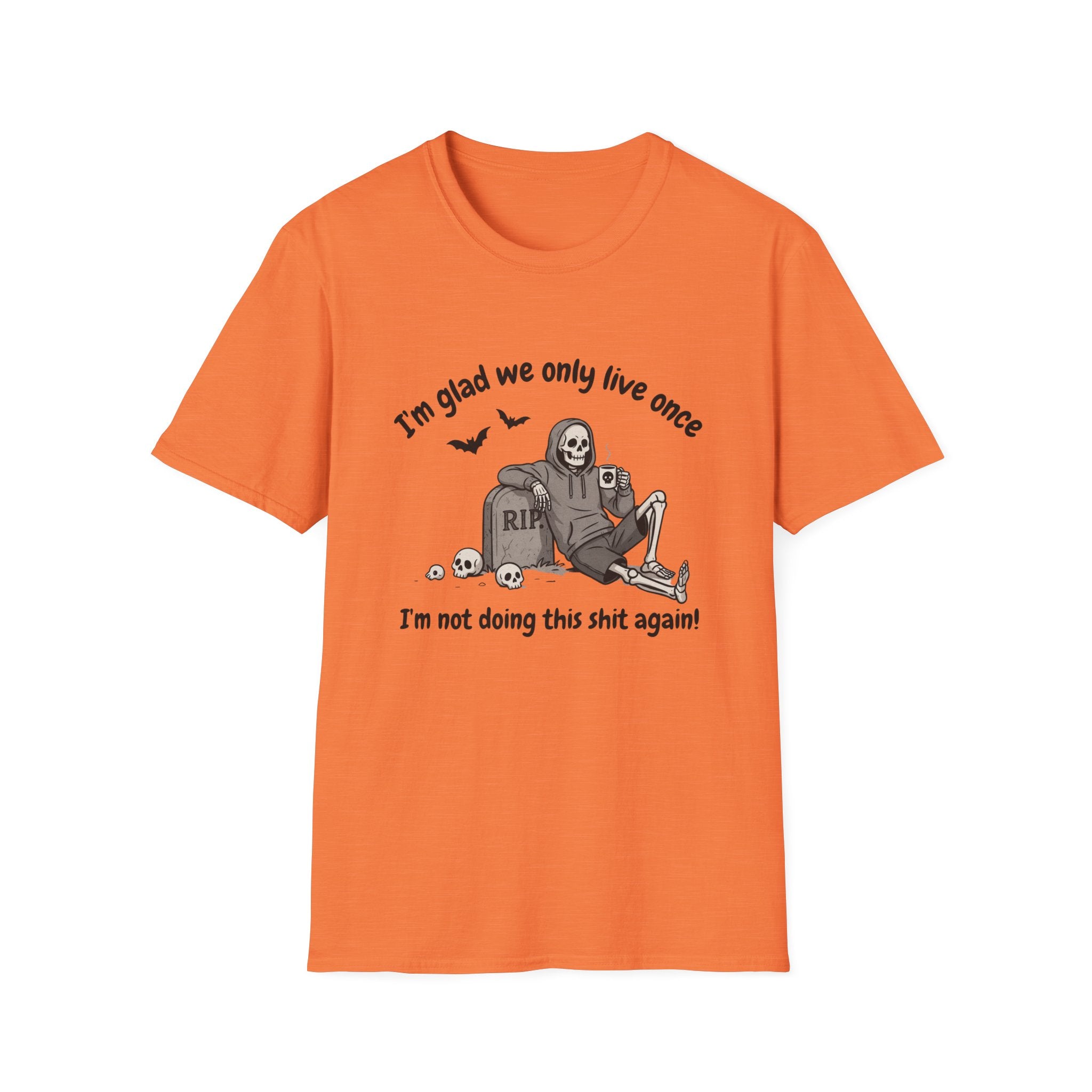 An orange short-sleeve crewneck t-shirt featuring a Halloween graphic of a skeleton sitting on a tombstone with the text 'I'm glad we only live once' and 'I'm not doing this shit again!'.